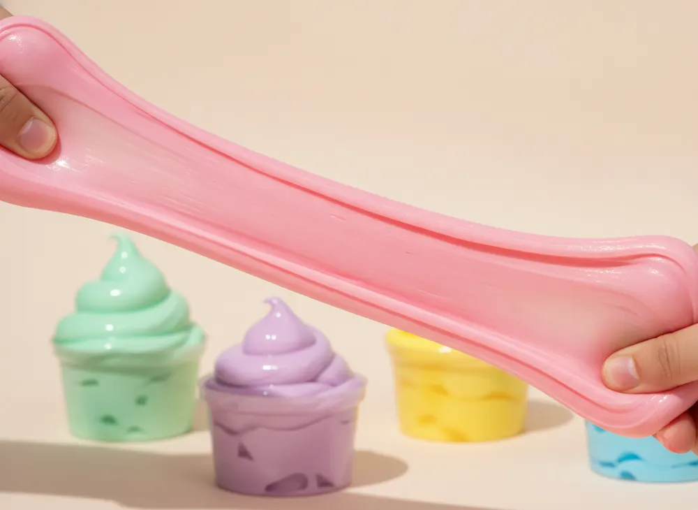 Hands stretching a wide ribbon of pink slime